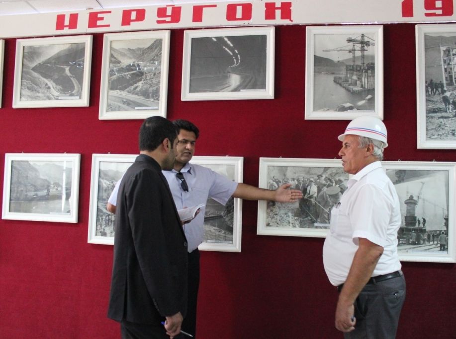 Уголок истории. На фото, на которое указывает переводчик, запечатлен Леонид Ильич Брежнев во время визита на строящуюся ГЭС в 1970 году.